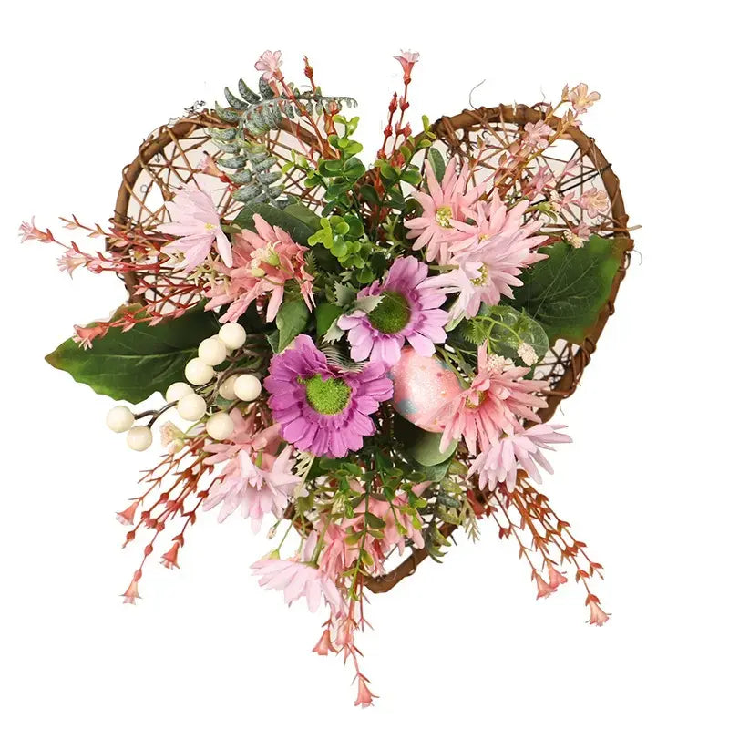 Artificial heart-shaped vine wreath with wild daisies, festive eggs, and green leaves.